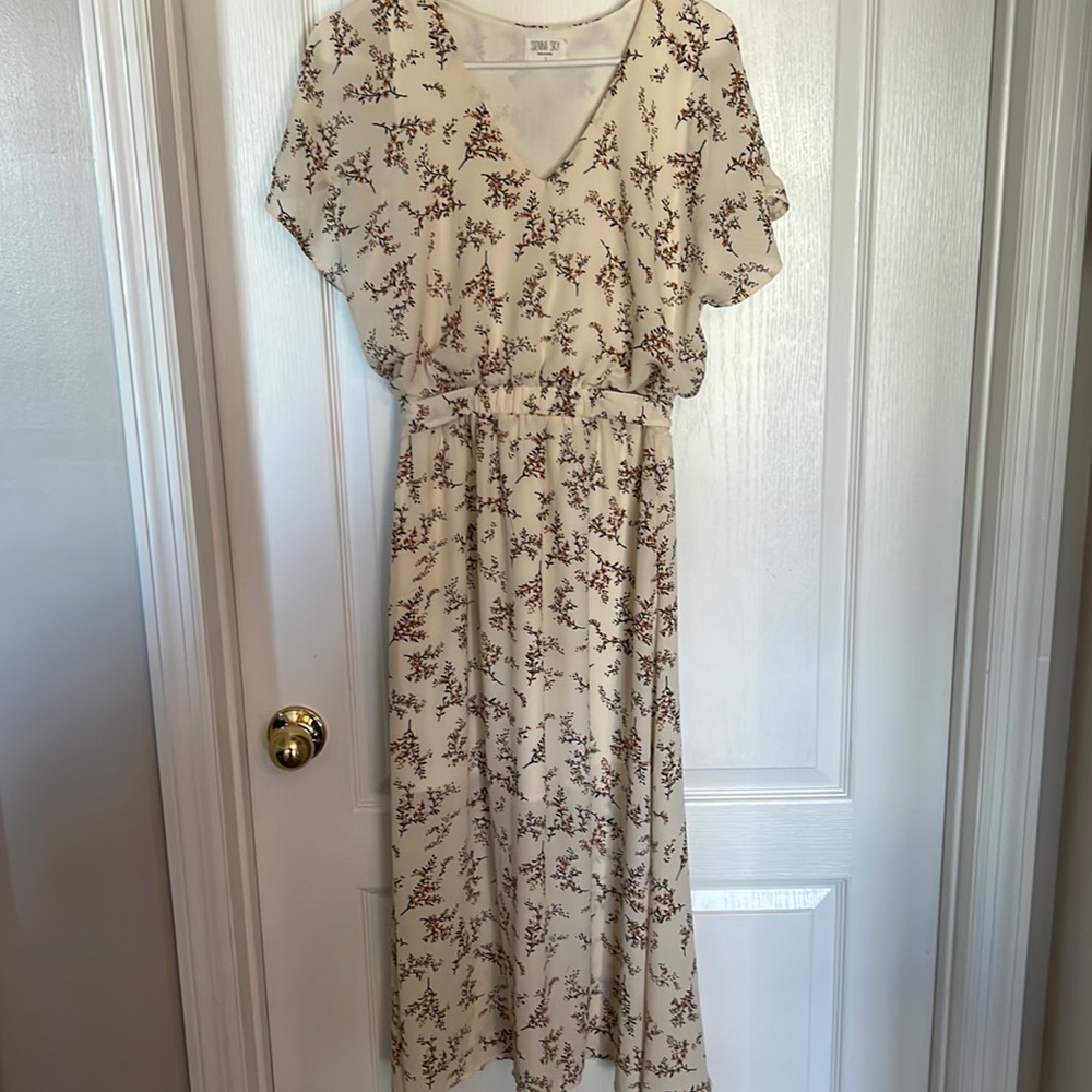 Sienna Sky cream colored dress.